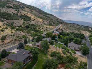 Aerial view of property and surrounding area featuring mountains