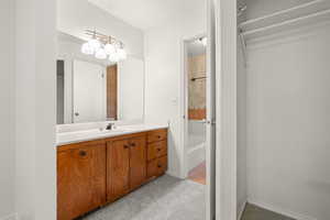 Bathroom with vanity, light carpet, and shower / bath combination
