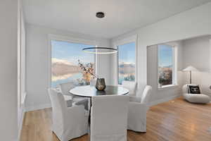 Dining space with a mountain view and light wood finished floors