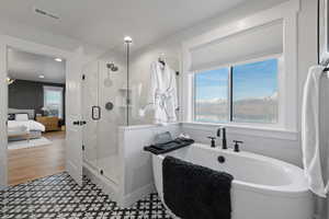 Ensuite bathroom with a shower stall and a soaking tub