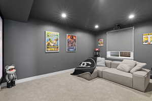 Carpeted home theater with recessed lighting and baseboards