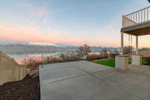 View of patio with a water and mountain view