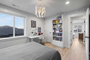 Bedroom featuring light wood-type flooring, recessed lighting, and a chandelier