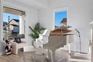 Living area with wood finished floors and baseboards
