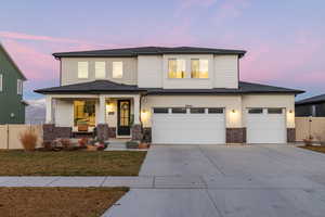 View of front of property with a gate, a porch, driveway, an attached garage, and stone siding