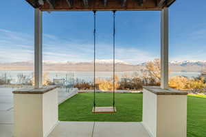 View of patio with a water and mountain view