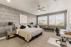 Carpeted bedroom featuring ceiling fan, a desk, and recessed lighting