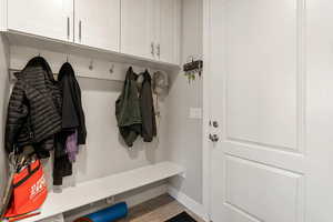 Mudroom featuring light wood finished floors and baseboards
