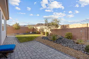 Fenced backyard with a patio