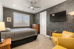 Carpeted bedroom featuring a ceiling fan and recessed lighting