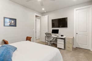 Bedroom featuring light carpet, a desk, a ceiling fan, and recessed lighting