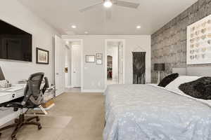 Bedroom featuring an accent wall, an office area, carpet floors, a ceiling fan, and recessed lighting