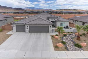 Mediterranean / spanish house with a residential view, a garage, stucco siding, and concrete driveway