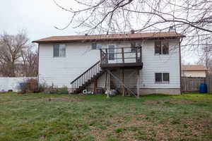 Rear view of property with stairway and a wooden deck