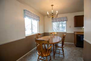 Dining room featuring a chandelier, with natural light