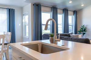 Kitchen view of a sink and recessed lighting