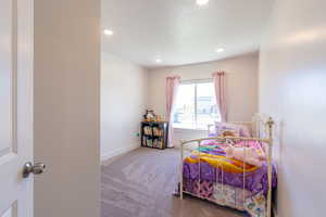 Carpeted bedroom featuring baseboards and recessed lighting