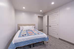Bedroom featuring carpet floors, recessed lighting, and a closet