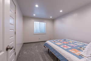 Bedroom featuring dark carpet and recessed lighting