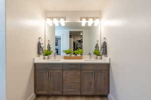 Bathroom featuring double vanity and light wood-style floors