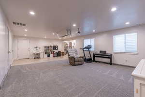 Sitting room with recessed lighting and carpet flooring