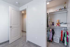 Bedroom with carpet, a closet, and recessed lighting