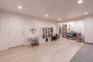 Home office with recessed lighting and light wood-type flooring