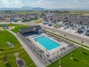 Aerial view of residential area with a pool and a mountainous background