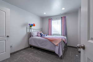 Carpeted bedroom featuring baseboards and recessed lighting