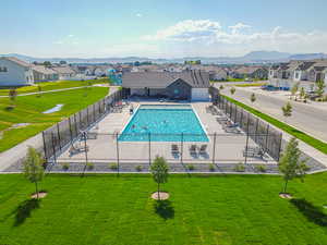 Community pool featuring a patio, a residential view, and a mountain view