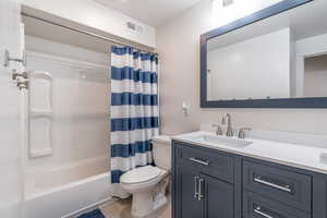 Full bathroom with vanity and shower / bath combo with shower curtain