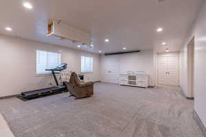 Workout area with recessed lighting and light carpet