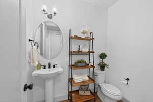 Bathroom with wood finished floors and hanging lights