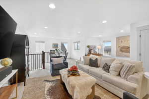 Living area with recessed lighting and light colored carpet
