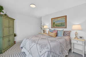 Carpeted bedroom with baseboards