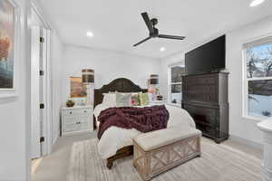 Bedroom featuring light carpet, a ceiling fan, and recessed lighting