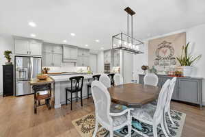 Dining room featuring light wood-style flooring and hanging lights