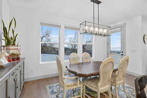 Dining area featuring light wood-style floors and baseboards