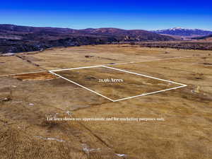 Aerial view of sparsely populated area featuring a mountainous background and a desert landscape