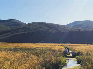View of mountain background featuring rural landscape