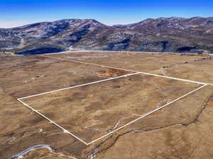 Overview of rural landscape featuring a mountainous background