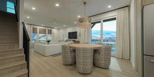 Dining area featuring light wood finished floors and recessed lighting