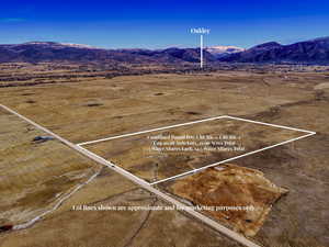 View of rural area featuring a mountain backdrop and property parcel outlined
