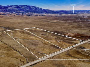 Aerial view of sparsely populated area featuring a mountainous background and a desert landscape