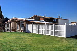 Rear view of house with brick siding and a chimney