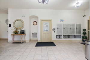 Entrance foyer featuring mail area and baseboards