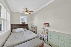Second Bedroom with crown molding and a ceiling fan