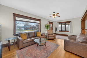 Living room with light wood-style flooring and ceiling fan
