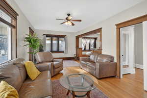 Living room with light wood finished floors and a ceiling fan