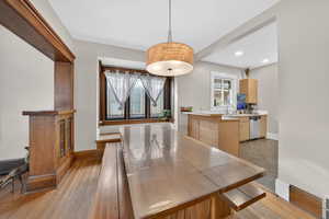 Dining space with light wood finished floors and recessed lighting